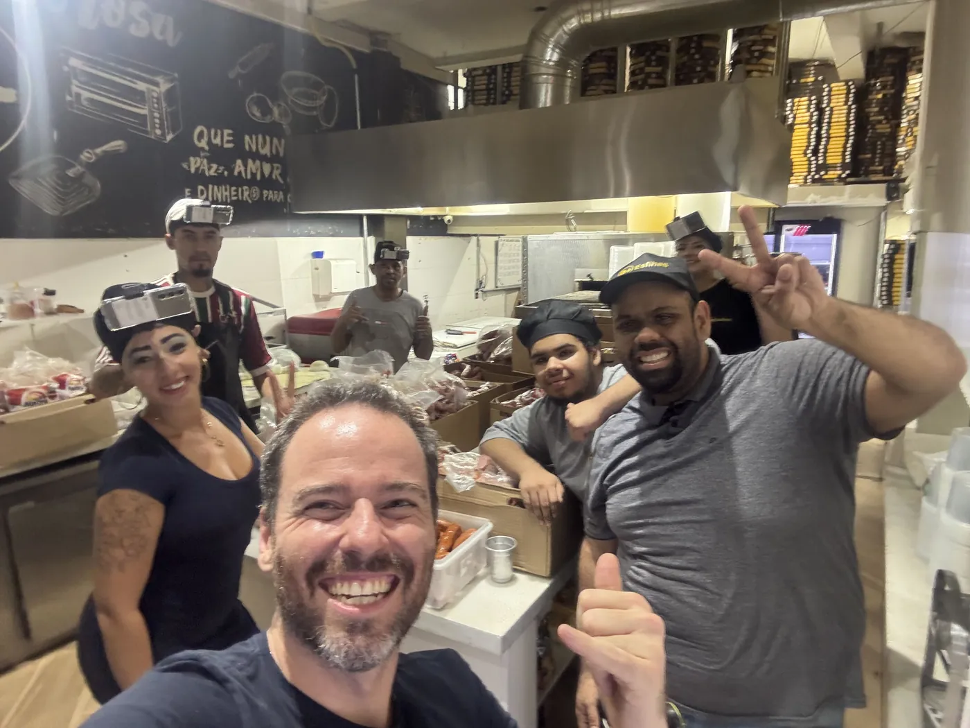 A kitchen crew and Hub operators with head rigs, all smiles